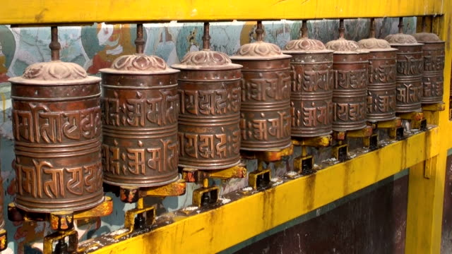 Spinning-Tibetan-Buddhist-prayer-wheels-at-Boudhanath-stupa,-Nepal