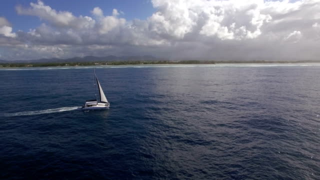 Sailing-yacht-and-island-coast,-aerial-shot