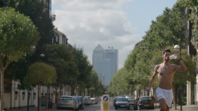 A-young-man-running-though-London-with-City-of-London-behind-him.