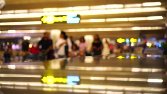 Travelers-passengers-in-airport-transit-terminal-walking-with-luggage-baggage-going-traveling.-Business-travel-people-out-of-focus-and-blurry-in-background-:-4k