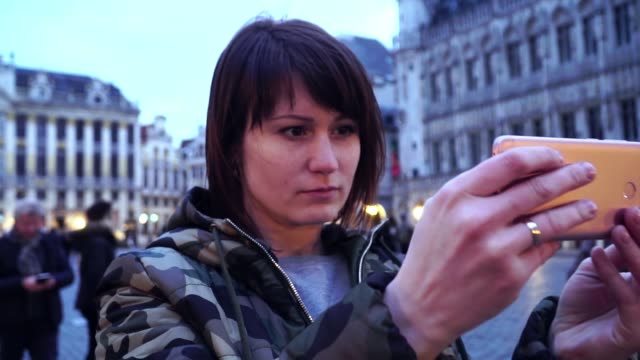Lady-tourist-takes-pictures-on-,-Belgium.slow-motion.-dolly-zoom-effect
