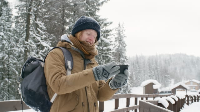 Joyous-Guy-Taking-Selfie-in-Winter-Forest