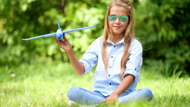 Neun-jährige-Mädchen-spielen-mit-Spielzeugflugzeug