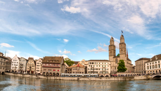 Zurich-Switzerland-time-lapse-4K,-city-skyline-timelapse-at-Limmat-River-with-Grossmunster-and-Predigerkirche-Church
