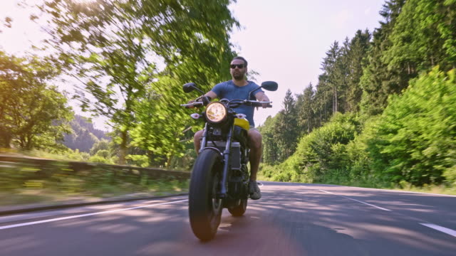 modern-scrambler-motorbike-on-the-forest-road-riding