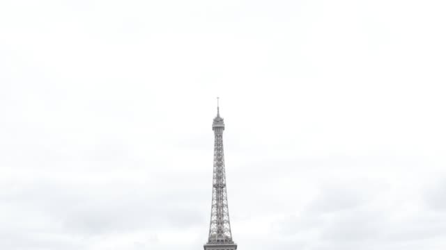 Slow-tilt-on-Eiffel-tower-lattice-construction-in-front-of-cloudy-sky-France-Paris-4K