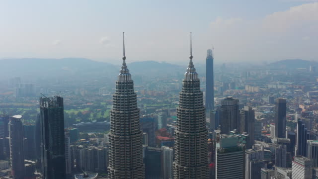 sunny-day-kuala-lumpur-city-downtown-famous-towers-tops-aerial-panorama-4k-malaysia