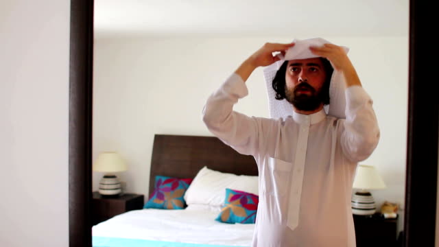Saudi-arabian-man-dressing-at-home