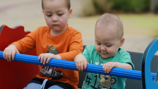 Two-Boys-Happily-Playing-on-a-Seesaw