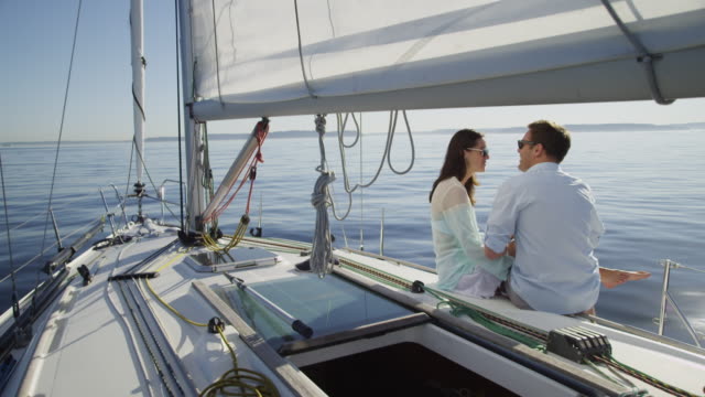 Young-couple-on-sailboat-together.
