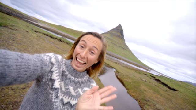 Slow-motion-Selfie-portrait-of-tourist-female-in-Iceland-at-Kirkjufell-mountain