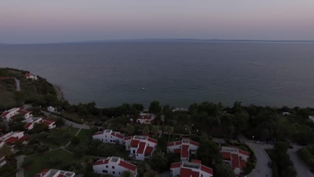 Aerial-scene-of-sea-and-cottages-on-the-shore.-Trikorfo-Beach,-Greece