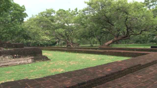 View-to-the-ruins-of-the-ancient-city-and-trees-in-Polonnaruwa,-Sri-Lanka.