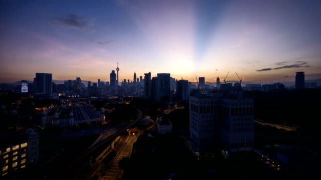 dramatic-sunrise-at-Kuala-Lumpur-city-with-sun-burst-ray.-Moving-and-changing-color-clouds.