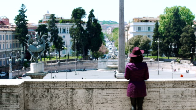 A-young,-elegant-tourist-looks-out-over-Piazza-del-Popolo-in-Rome