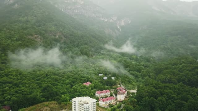 Dark-foggy-rainy-clouds-above-the-mountain-europe-village-house-in-the-forest