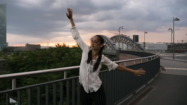 Young-Woman-Dancing-on-City-Bridge