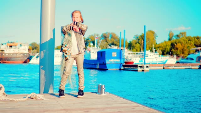 Girl-with-fishing-nets-posing-on-camera-at-dock