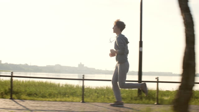 Woman-Jogging-on-Lakeside-Promenade