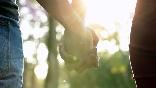 Hands-held-together-with-sunlight-flare-in-the-background