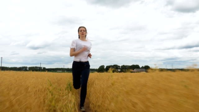 Young-Woman-Runs-Through-a-Golden-Grass-Field-2