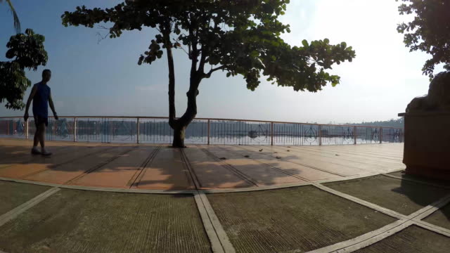 Man-walk-lake-shore-gazebo-view-deck-boardwalk-as-their-exercise-venue.