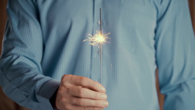 Footage-businessman-holding-sparkler-and-celebrating-new-year-or-success-business