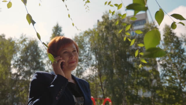 Happy-redhead-woman-calling-and-talking-on-phone