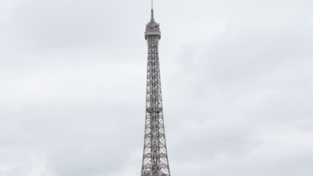 Tilting-on-Eiffel-tower-and-symbol-of-France-in-front-of-cloudy-sky