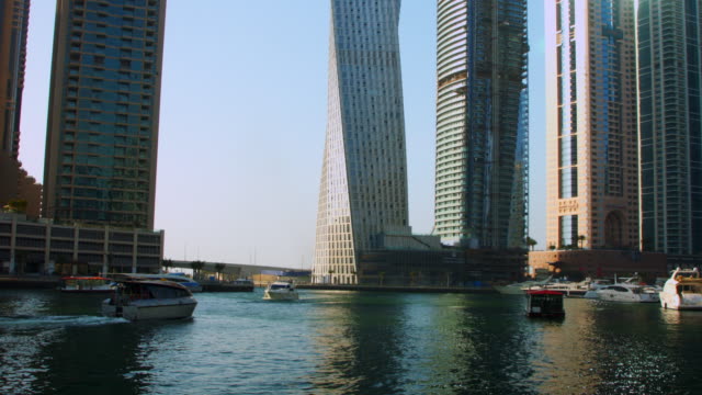 Locked-On-shot-of-a-ferry-boat-moving-on-river,-Dubai,-United-Arab-Emirates