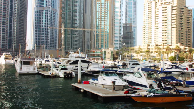 Locked-on-shot-of-boats-docked-at-harbor,-Dubai,-United-Arab-Emirates