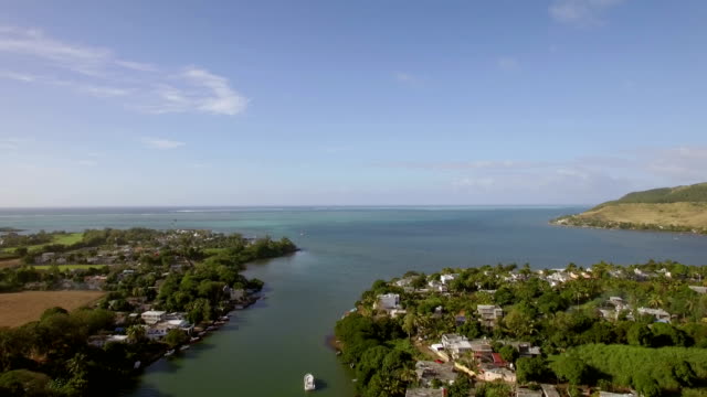 Coastal-town-and-river-falling-into-ocean.-Mauritius-aerial-view