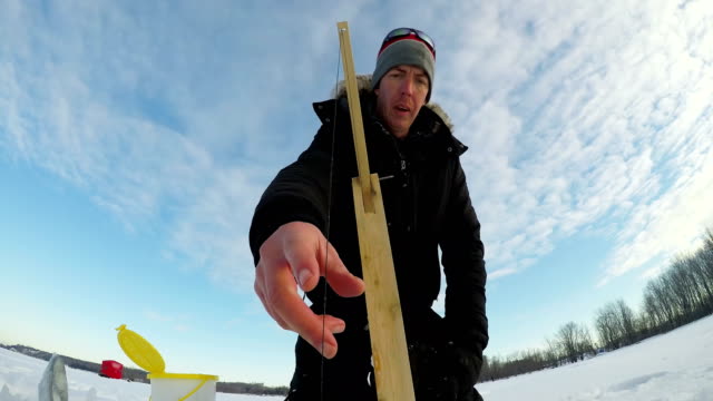 Ice-fisherman-setting-up-the-bait-for-fishing