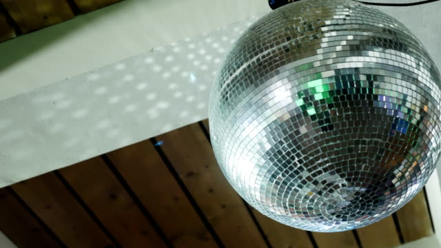 spinning-disco-ball-under-a-wooden-ceiling