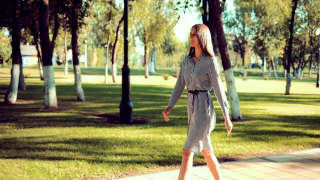 Young-beautiful-girl-walks-in-the-park-at-a-rapid-pace
