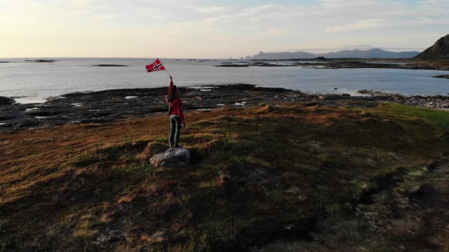 Andoya-island-sea-coast-and-tourist-with-norwegian-flag