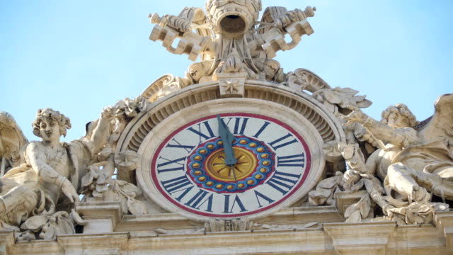 The-clock-about-to-strike-12-noon-from-the-Basilica-of-Saint-Peter-in-Vatican-Rome-Italy
