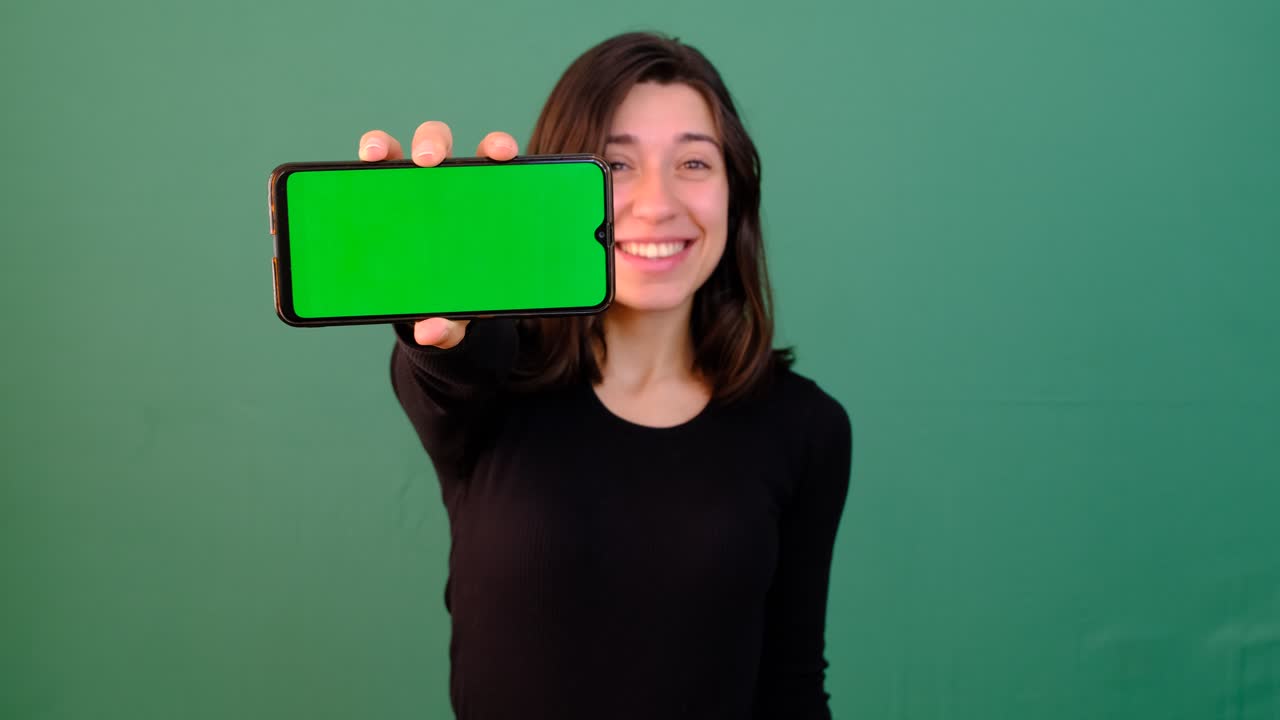 Premium stock video - Girl showing greenscreen