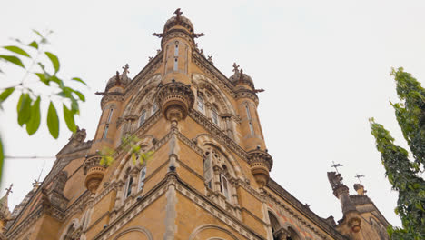 Exterior-Of-CSMT-Railway-Station-In-Mumbai-India-With-Leaves-In-Foreground-1
