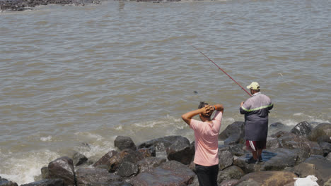 Close-Up-Of-Waves-Breaking-On-Bandra-Fort-In-Mumbai-India-With-People-Fishing