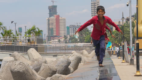 Children-Running-Towards-Camera-Along-Wall-On-Dadar-Beach-Mumbai-India