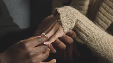 Close-Up-Of-Man-Putting-Engagement-Ring-On-Woman's-Finger-As-He-Proposes-Marriage-1