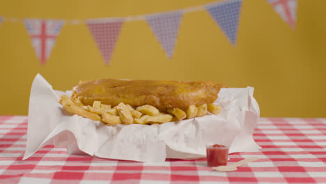 Studio-Shot-Of-Traditional-British-Takeaway-Meal-Of-Fish-And-Chips-3