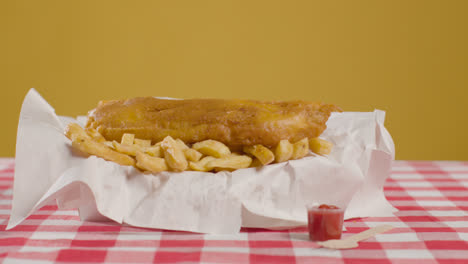 Studio-Shot-Of-Traditional-British-Takeaway-Meal-Of-Fish-And-Chips-4