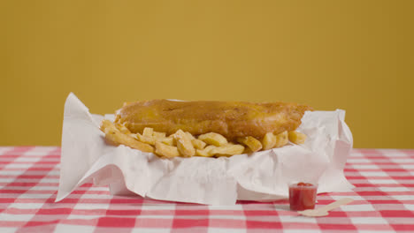Studio-Shot-Of-Traditional-British-Takeaway-Meal-Of-Fish-And-Chips-5