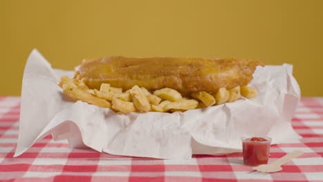 Studio-Shot-Of-Traditional-British-Takeaway-Meal-Of-Fish-And-Chips-6