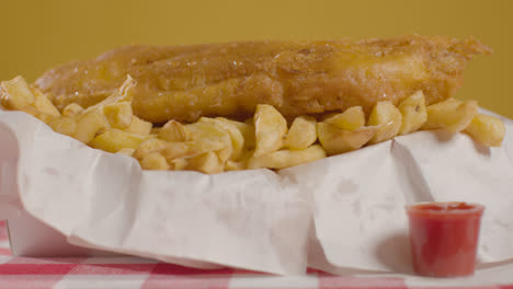 Close-Up-Studio-Shot-Of-Traditional-British-Takeaway-Meal-Of-Fish-And-Chips-With-Vinegar-1