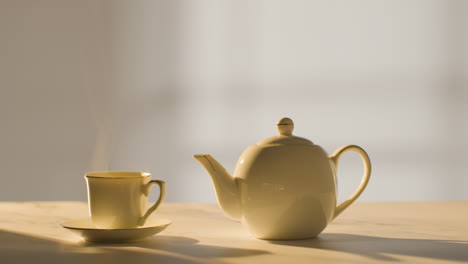 Studio-Shot-Of-Making-Traditional-British-Cup-Of-Tea-Using-Teapot-3