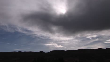 Long-shot-of-sunlight-shining-through-storm-clouds