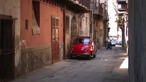 Cars-parked-along-stone-buildings-in-a-tightly-spaced-alley-Palermo-Italy